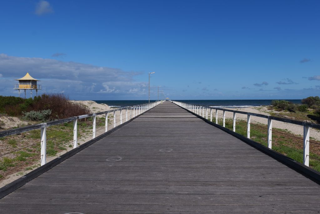 Explore a beautiful boardwalk leading to the ocean in Adelaide, South Australia.