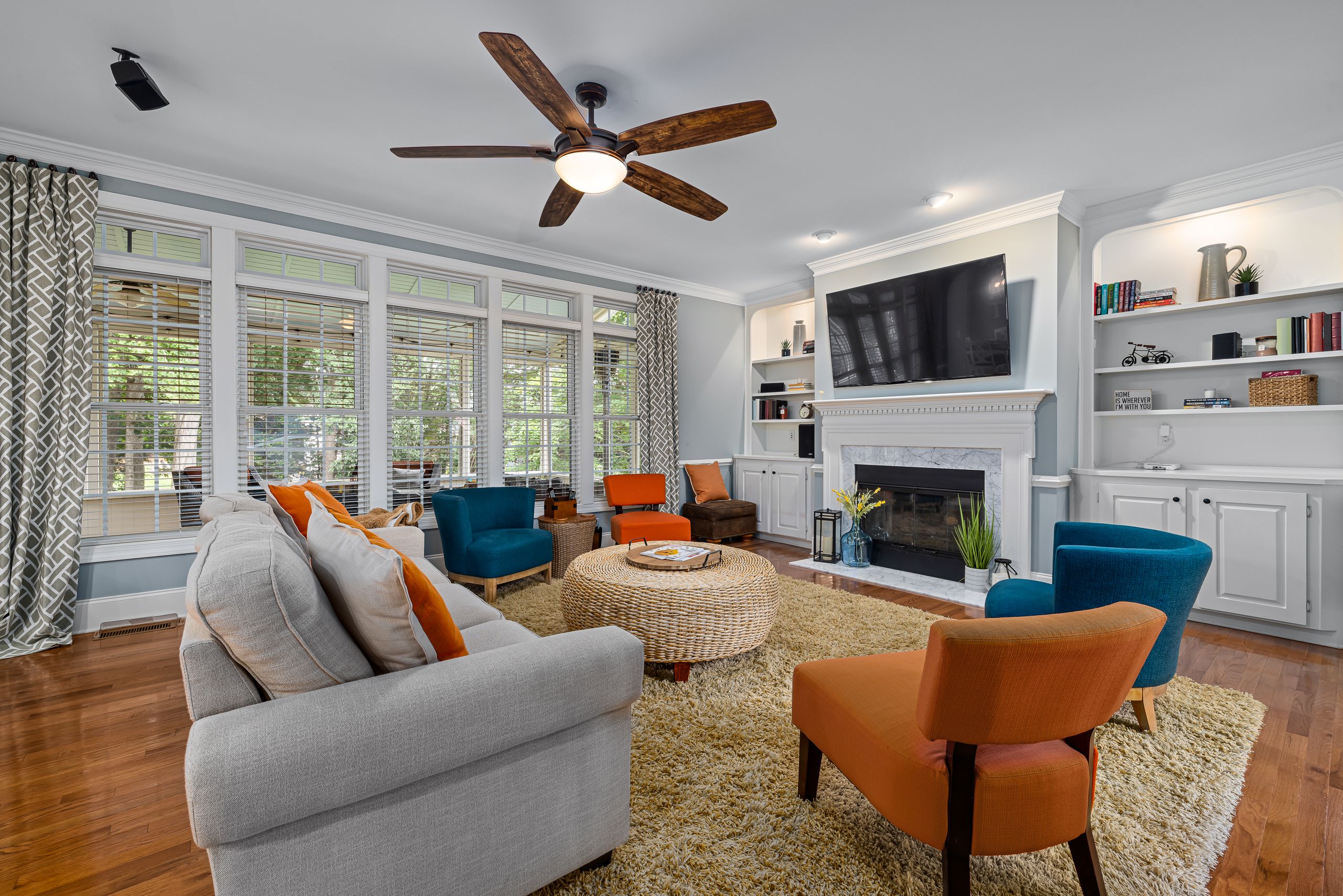 Stylish modern living room featuring a fireplace, television, and contemporary furniture.